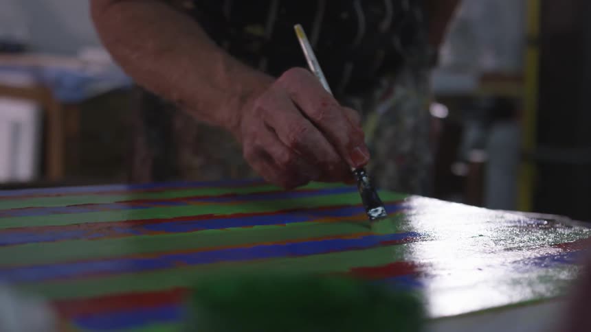 Older Man Painting In Studio