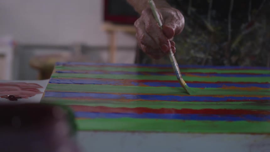 Older Man Painting In Studio
