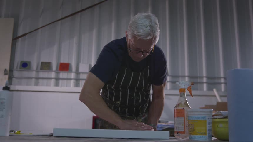 Older Man Painting In Studio