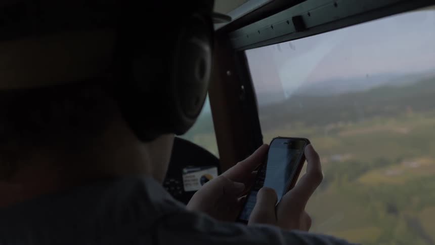 Pilot Flying Plane Through Snowy Mountains
