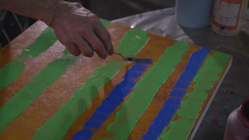 Older Man Painting In Studio