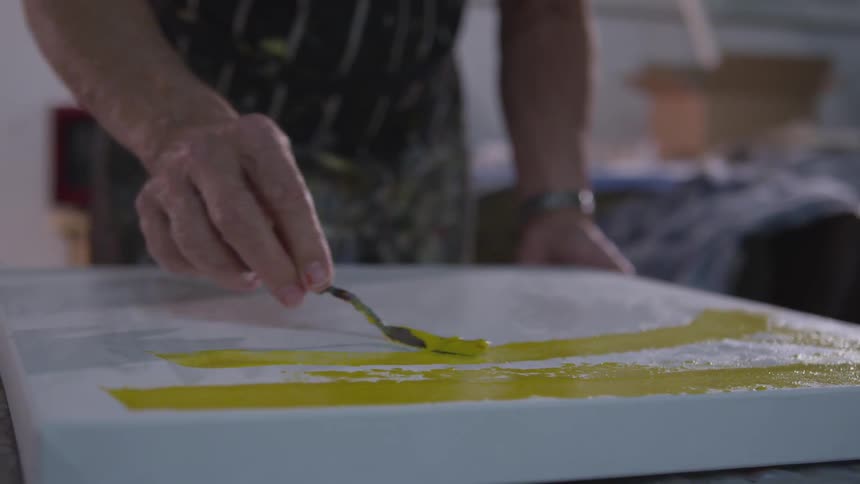 Older Man Painting In Studio