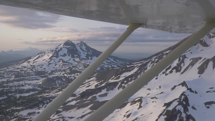 Pilot Flying Plane Through Snowy Mountains