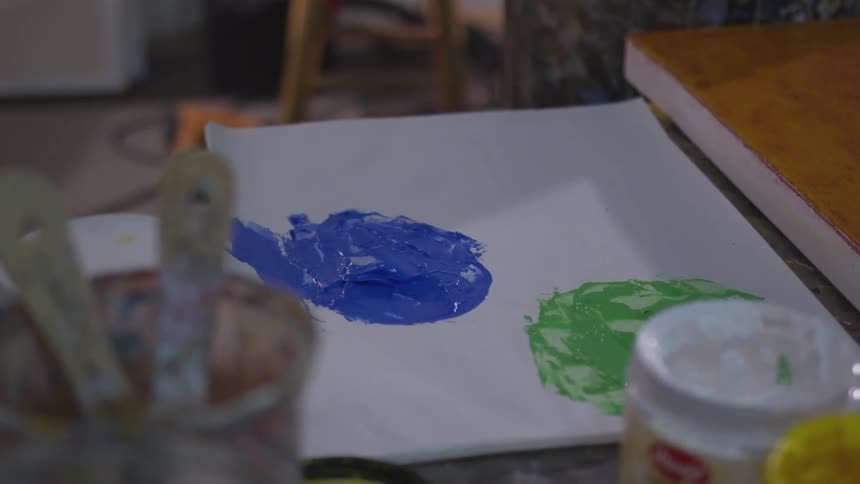 Older Man Painting In Studio