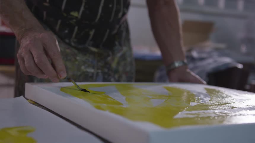 Older Man Painting In Studio