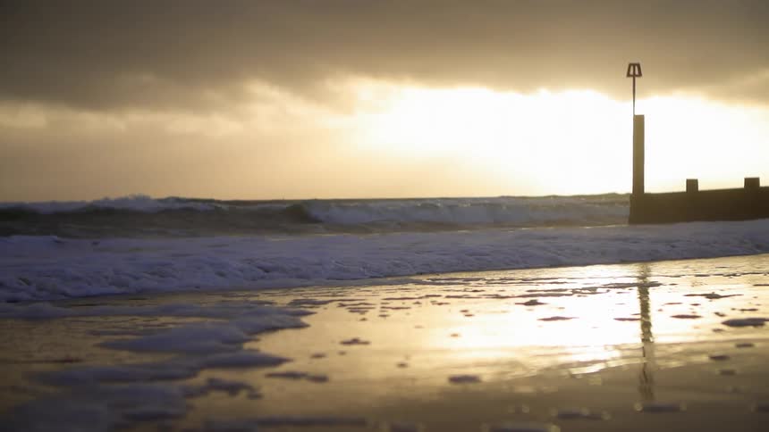 Stormy clouds hang over an empty beach