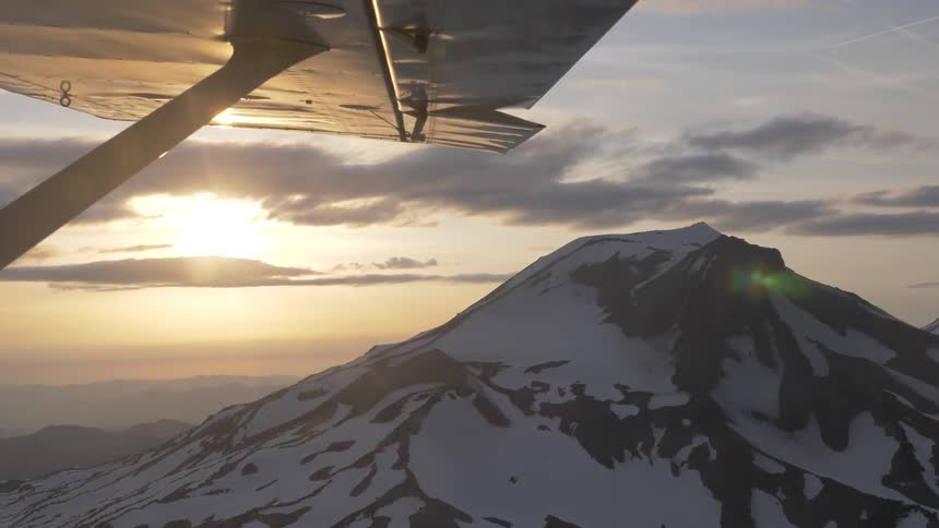 Pilot Flying Plane Through Snowy Mountains