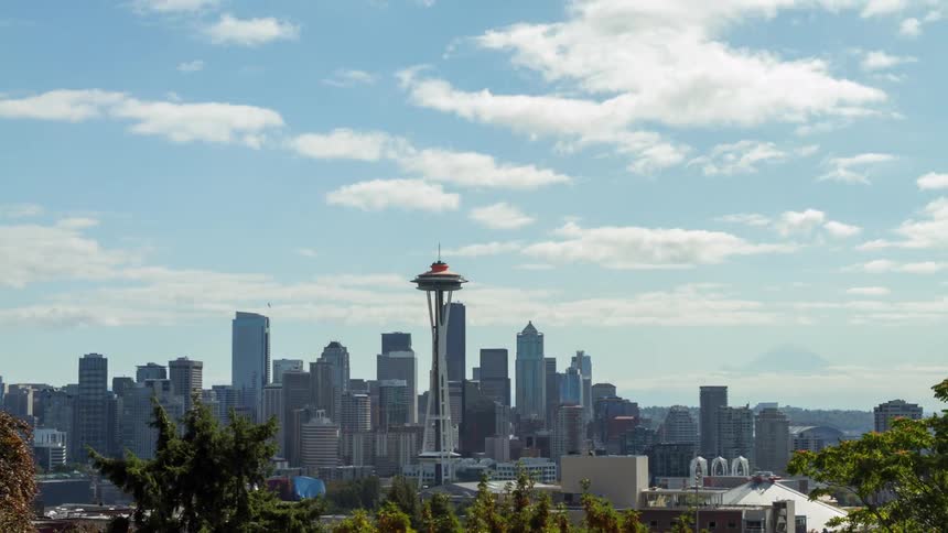 Time-lapse scene of light clouds passing over a large city