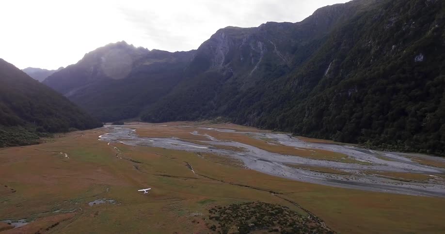Aerial view of streams going between mountains