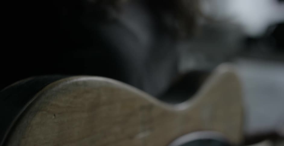 A wire being plugged into a guitar