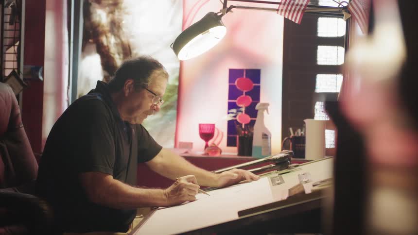 Man sitting at design table working