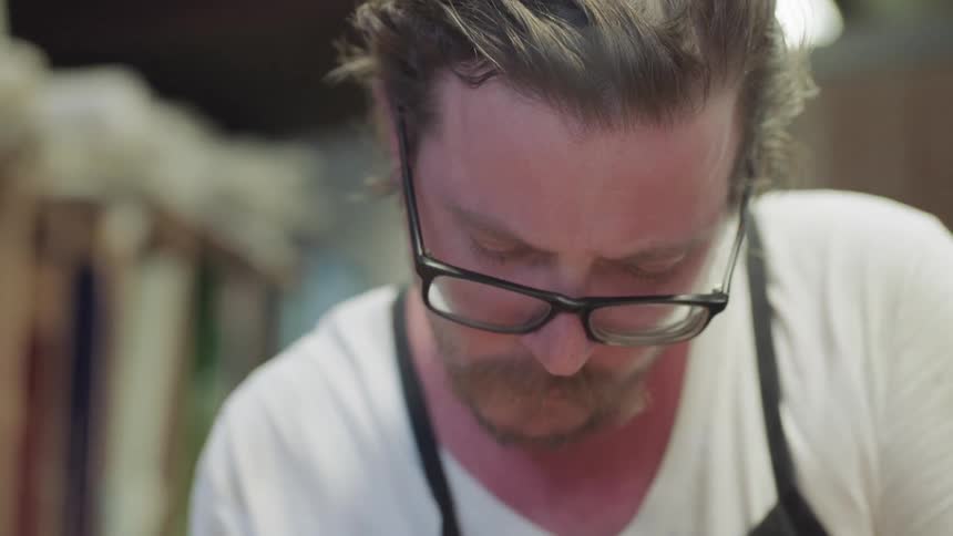 Man wearing glasses looking down