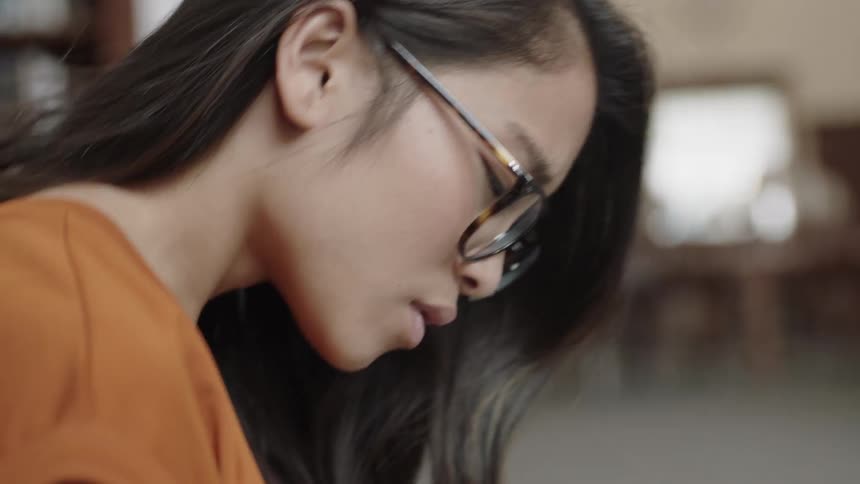 Female looking down at book