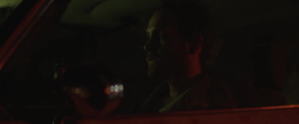 A man drives in a car during a rainstorm