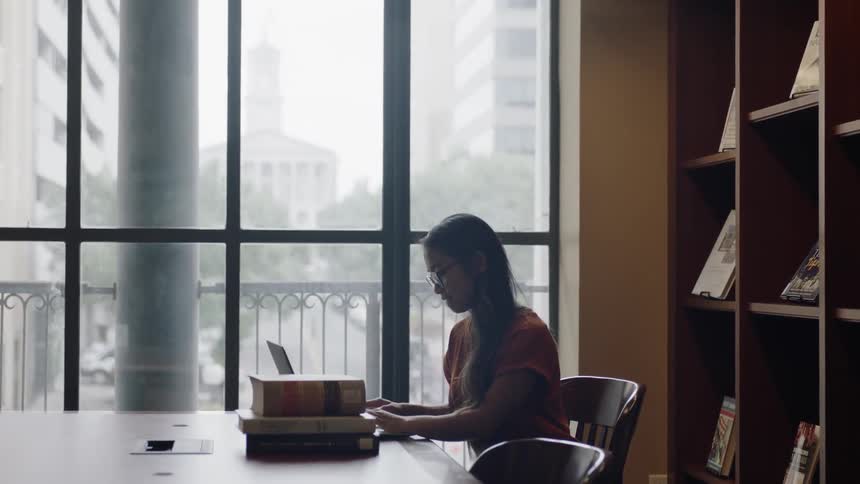 Large window with student working at table
