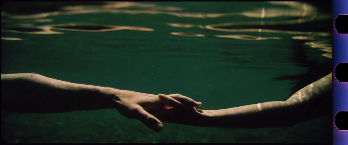 Hands reaching and touching underwater