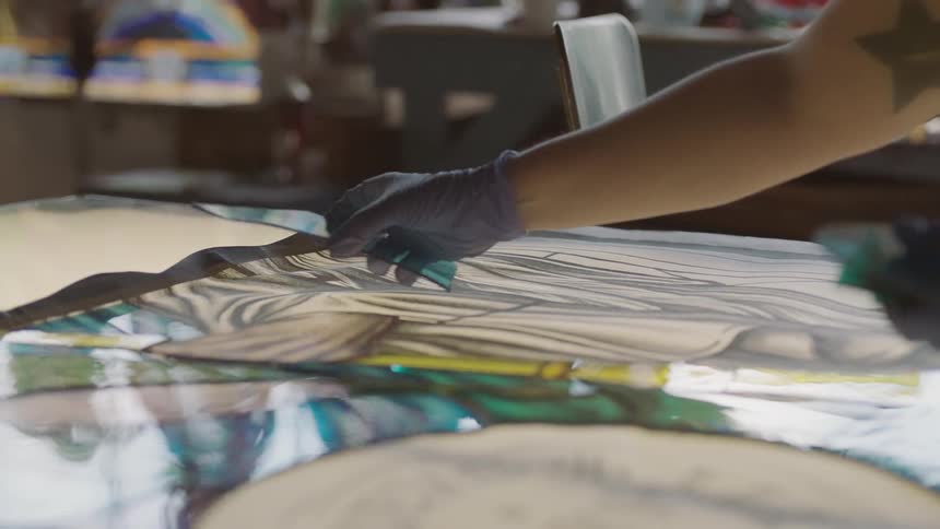 Hand moving peices of colored glass