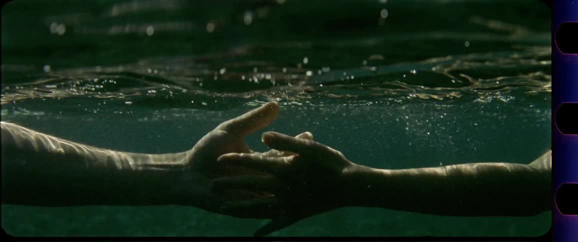 Hands reaching and touching underwater