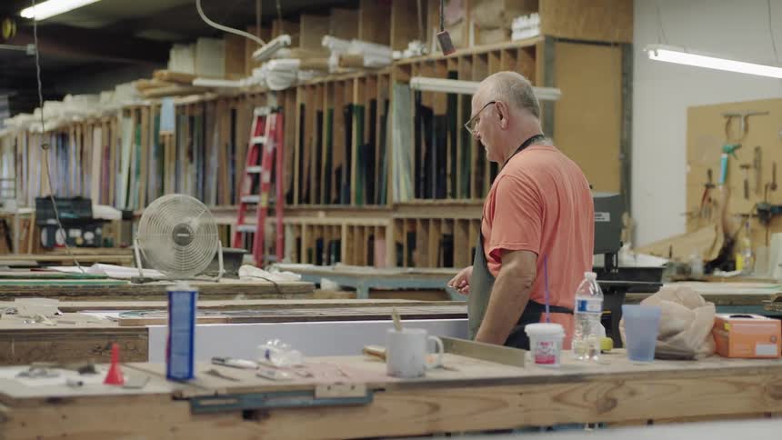 Older man walking in work space