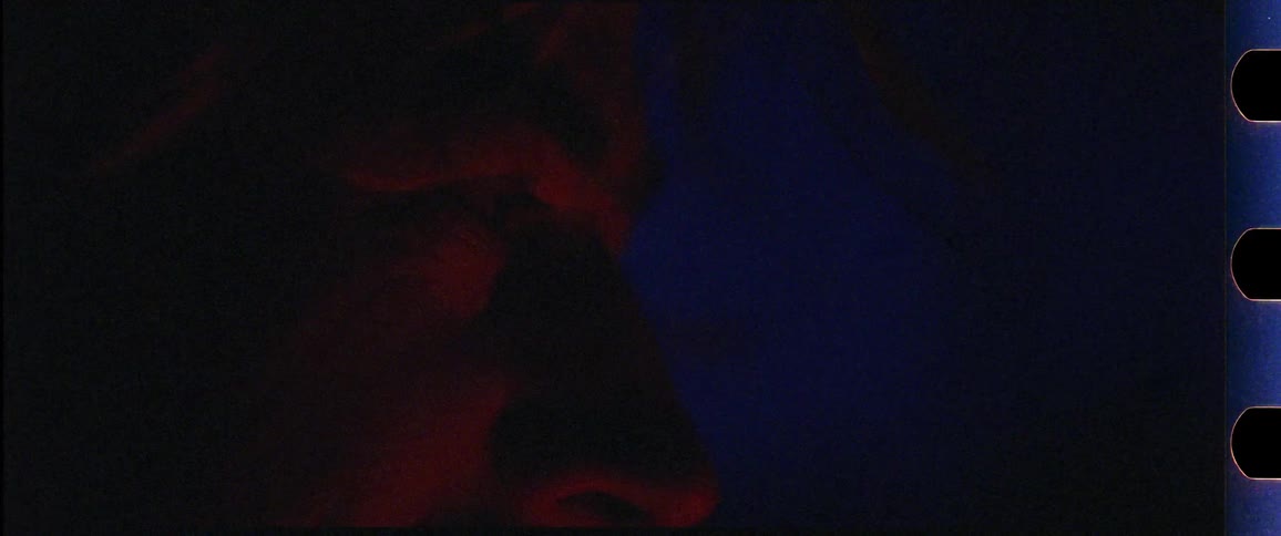 Closeup of a man with his face lit up from a fire