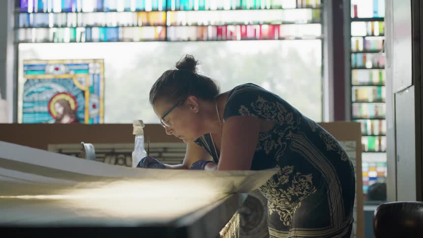 Artist looking at paper on table