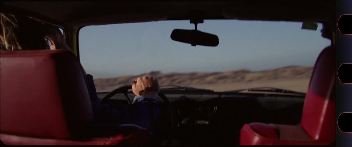 Interior shot couple drifting through desert scenery