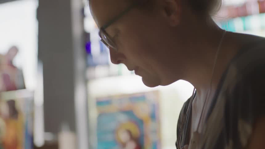 Female artist placing down pieces in artwork