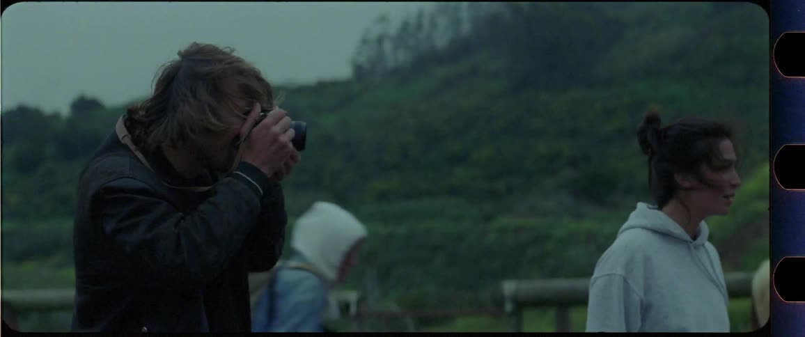 Man taking a picture while standing next to a woman
