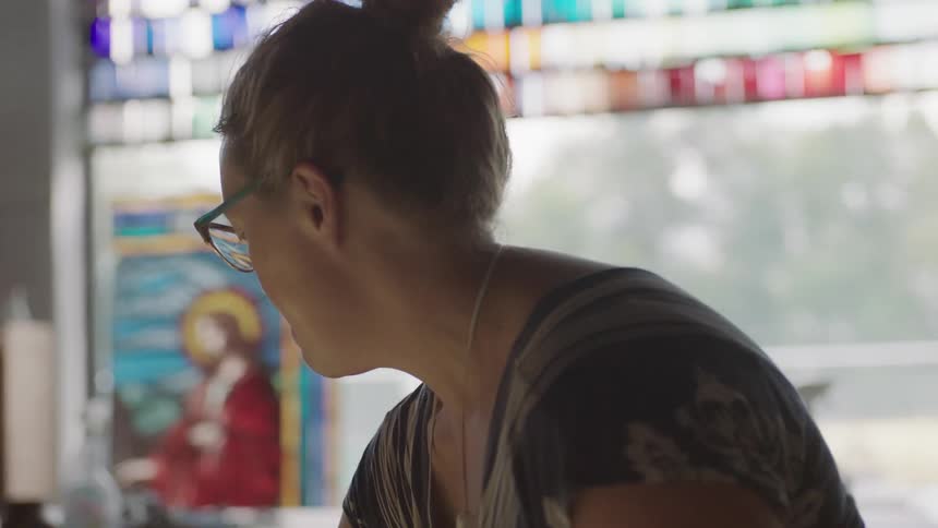 Colorful window behind woman in art studio