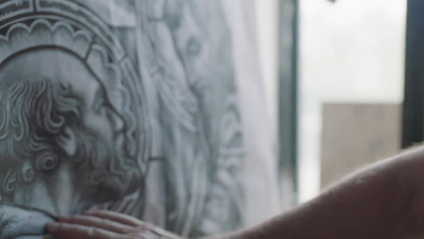 Man looks at and touches image on canvas