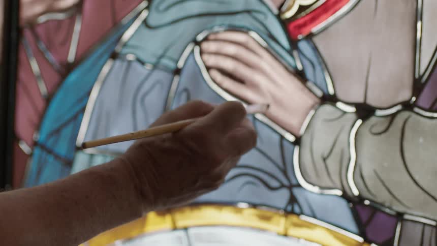 Man painting stain glass image