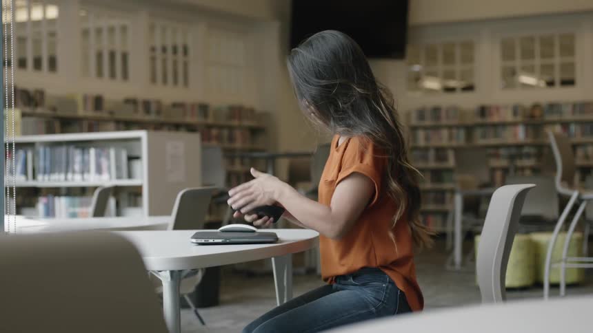 Student sitting down at library table