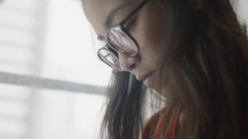 Brown haired woman looking down in diary