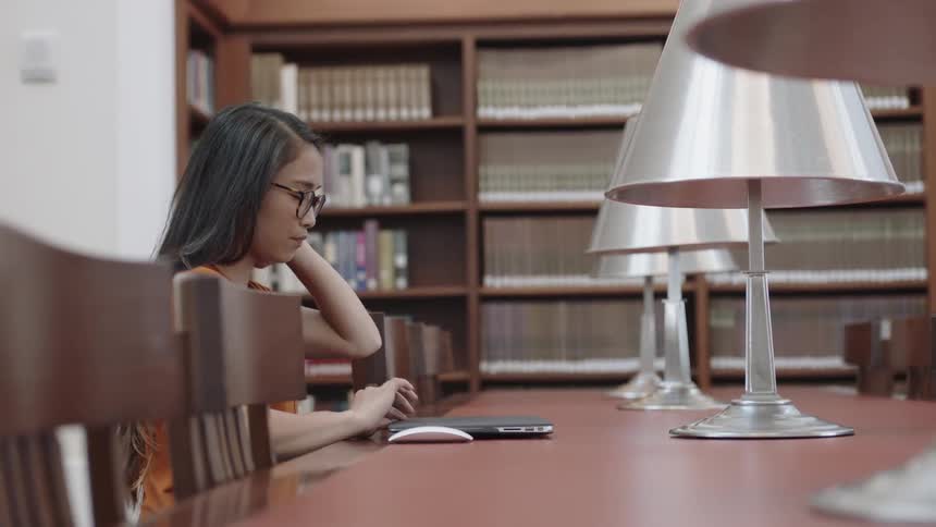 Student sitting down at library table