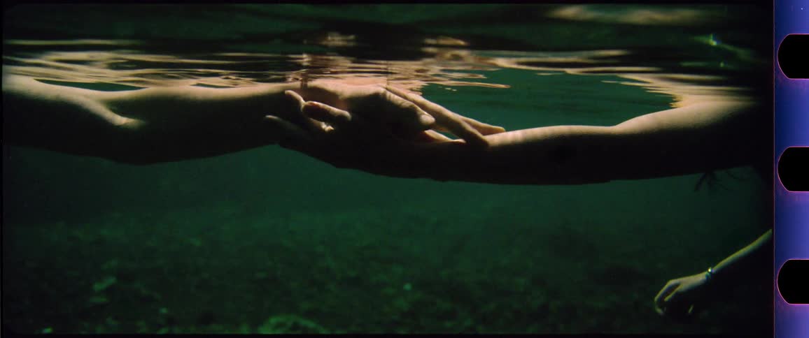 Hands reaching and touching underwater