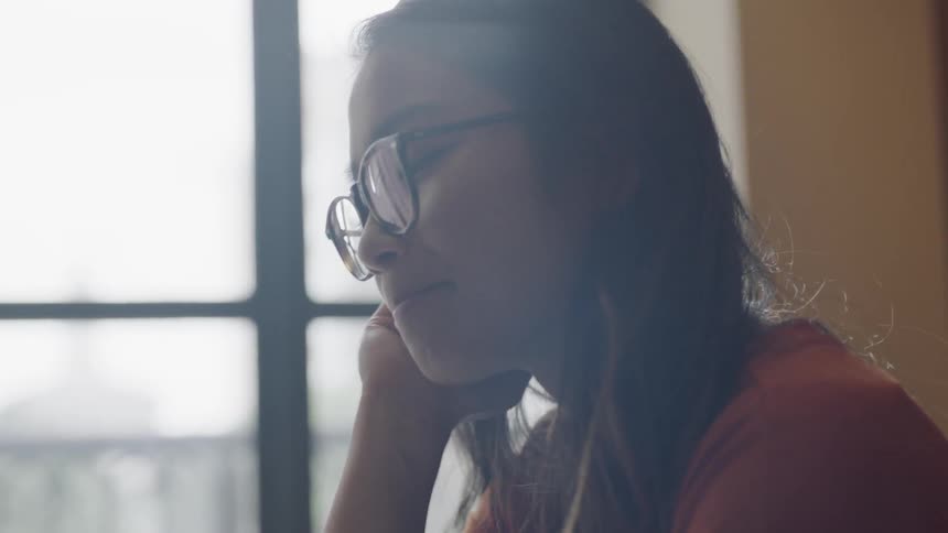 Woman looking down and talking