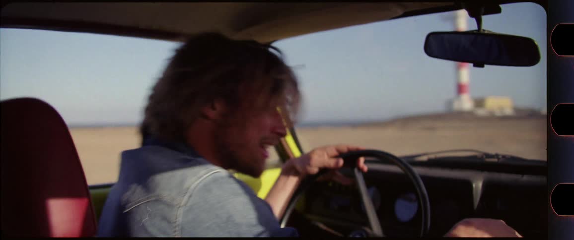 Man driving through beach scenery having a good time