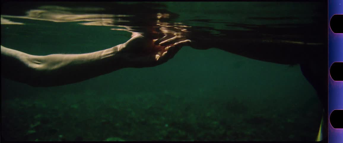 Hands reaching and touching underwater