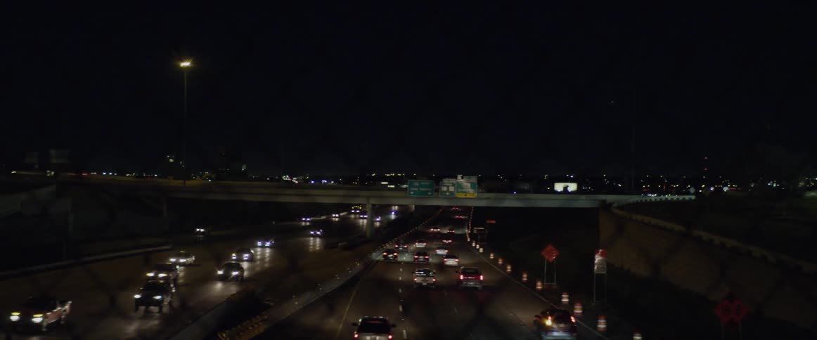Traffic moving in both directions on a highway at night