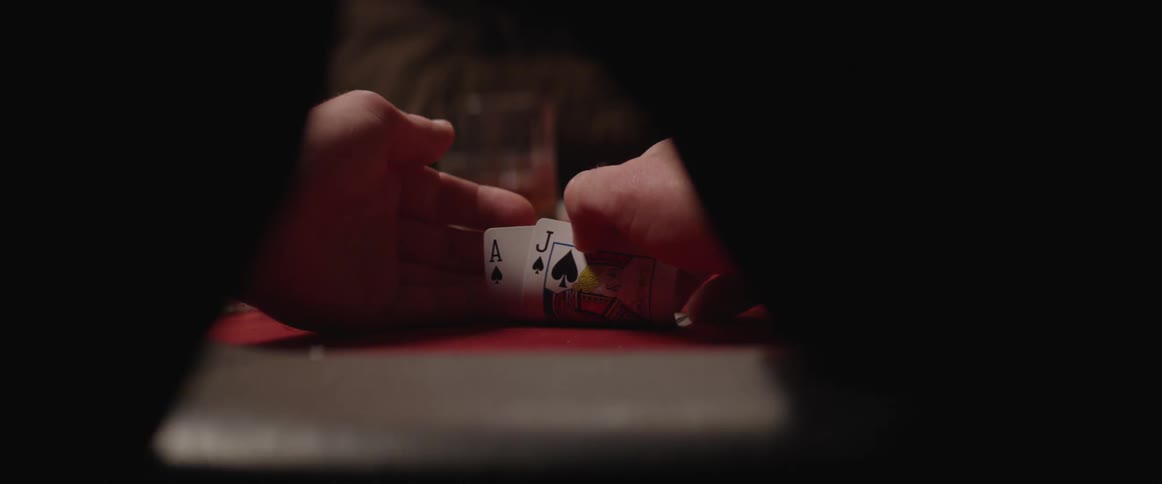 A player checks a blackjack hand and holds a jack and an ace