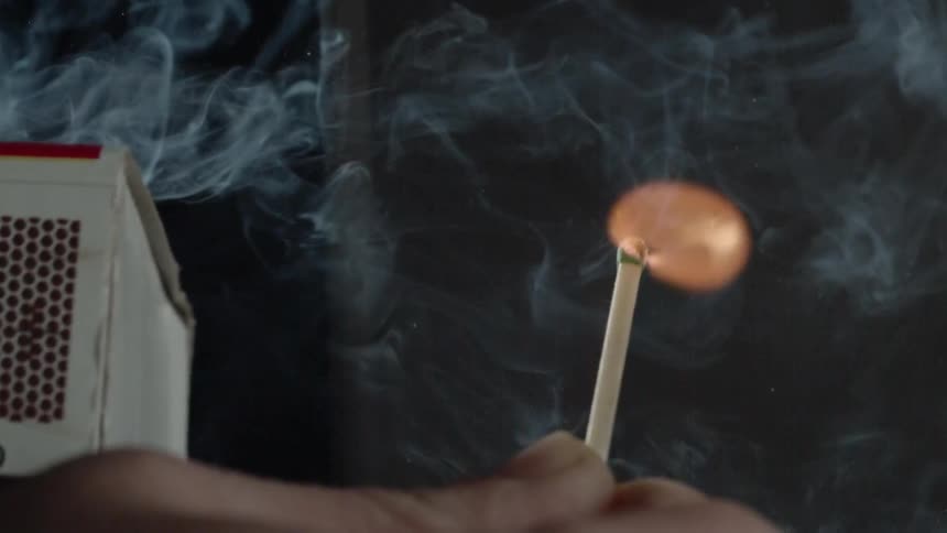 Slow motion match being lighted