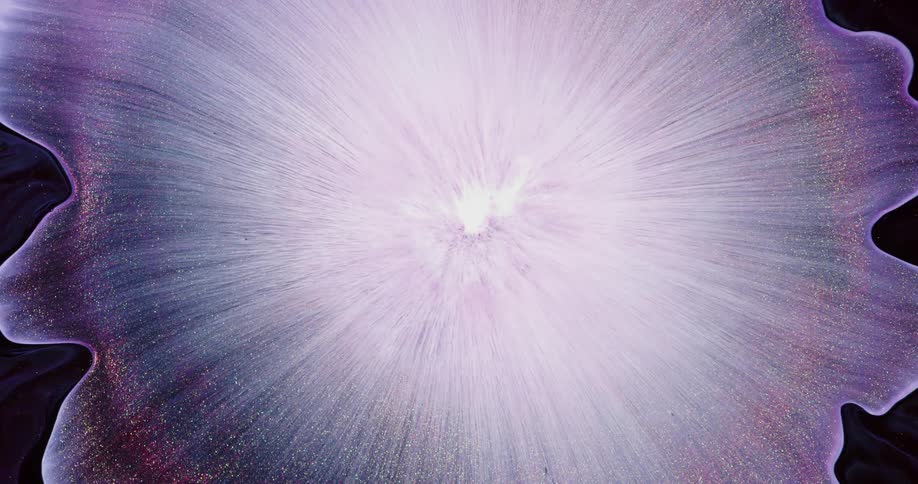 A drop of ink and glitter creates a starburst