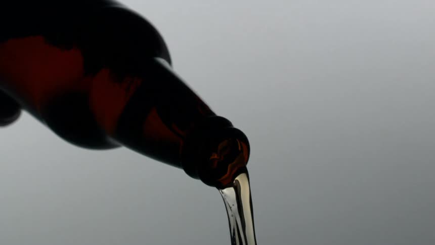 Pouring liquid from a brown bottle