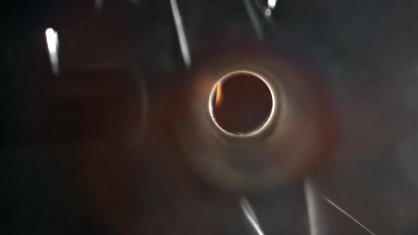 A gas burner is lit and flames