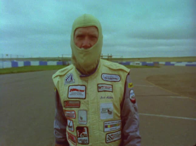 Race car drivers are shown on a track