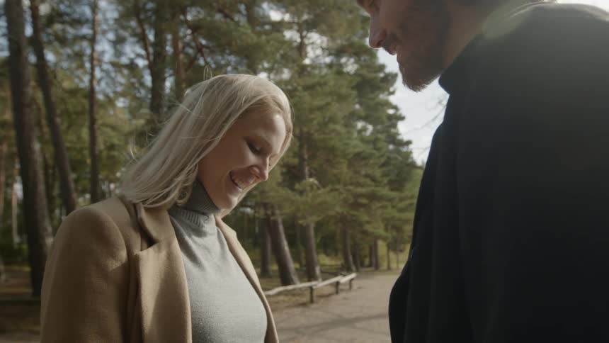Expecting Couple Walking In The Forest
