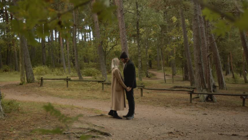 Expecting Couple Walking In The Forest