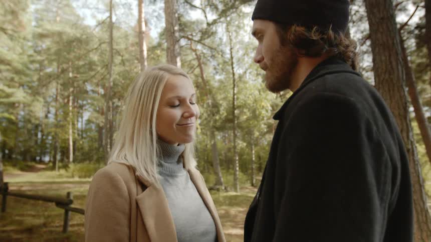 Expecting Couple Walking In The Forest