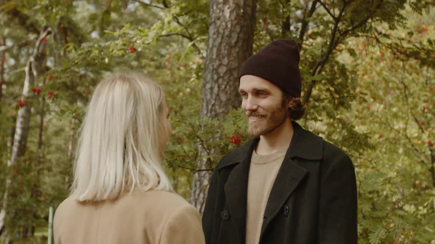 Expecting Couple Walking In The Forest