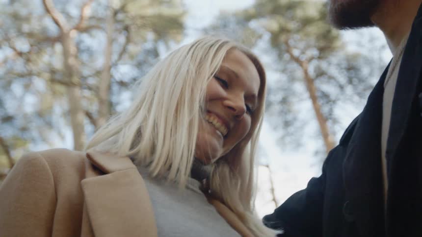 Expecting Couple Walking In The Forest
